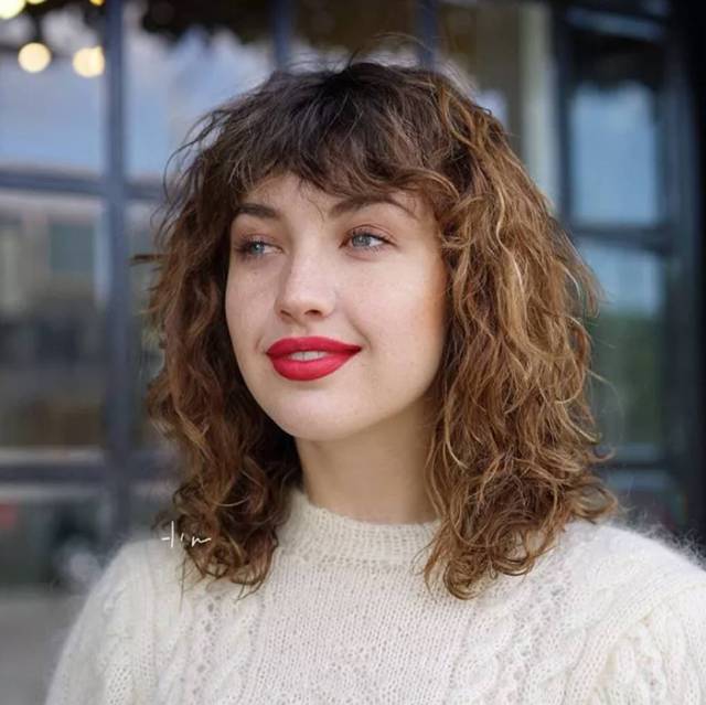 Layered Curly Hair with Baby Bangs