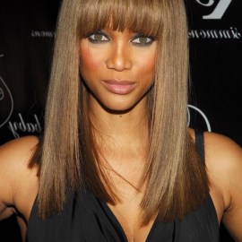 long sleek hairstyle with blunt bangs for black women Tyra Banks hairstyle